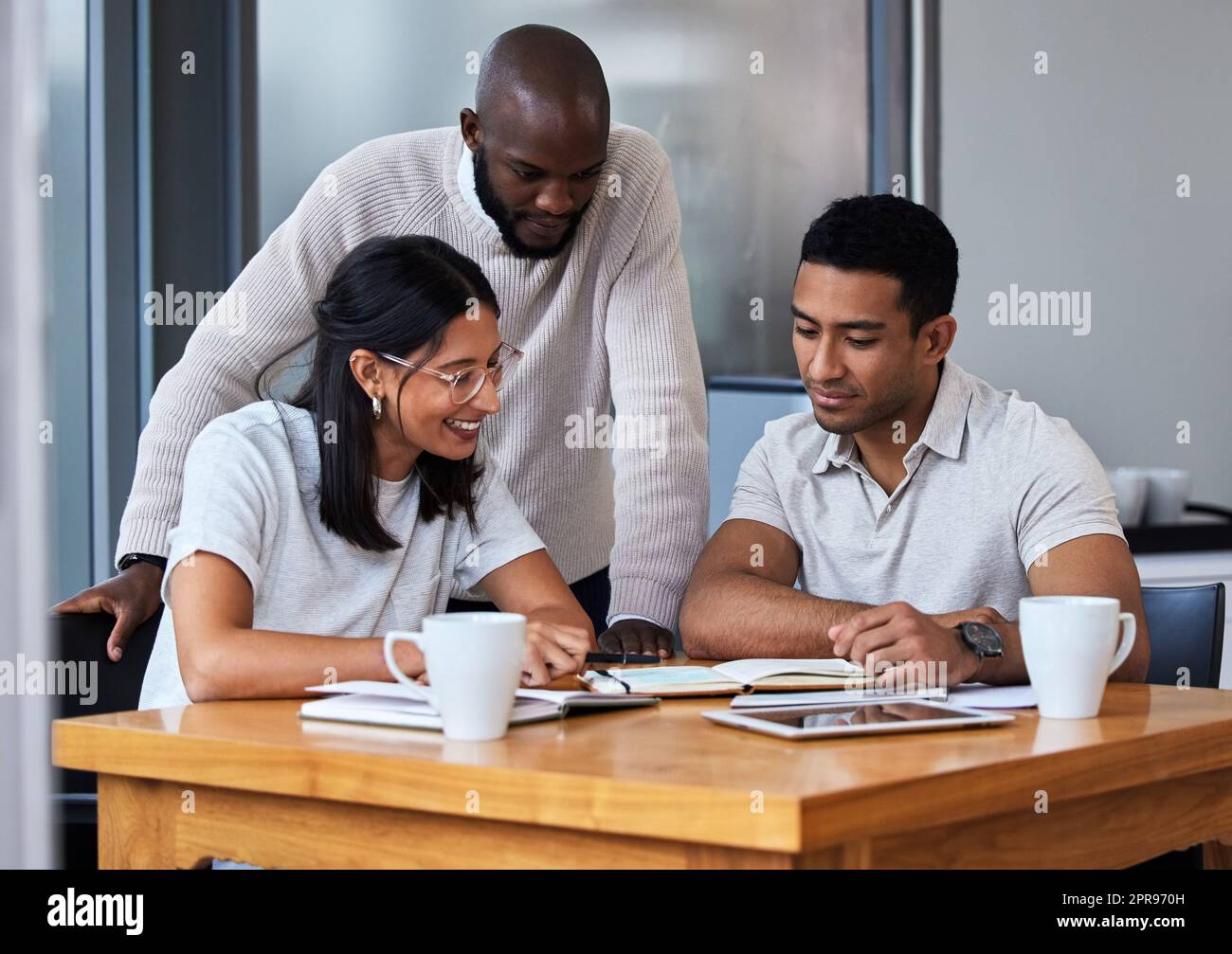 Common ground, where legends meet. diverse group of businesspeople having a quick meeting in an office. Stock Photo