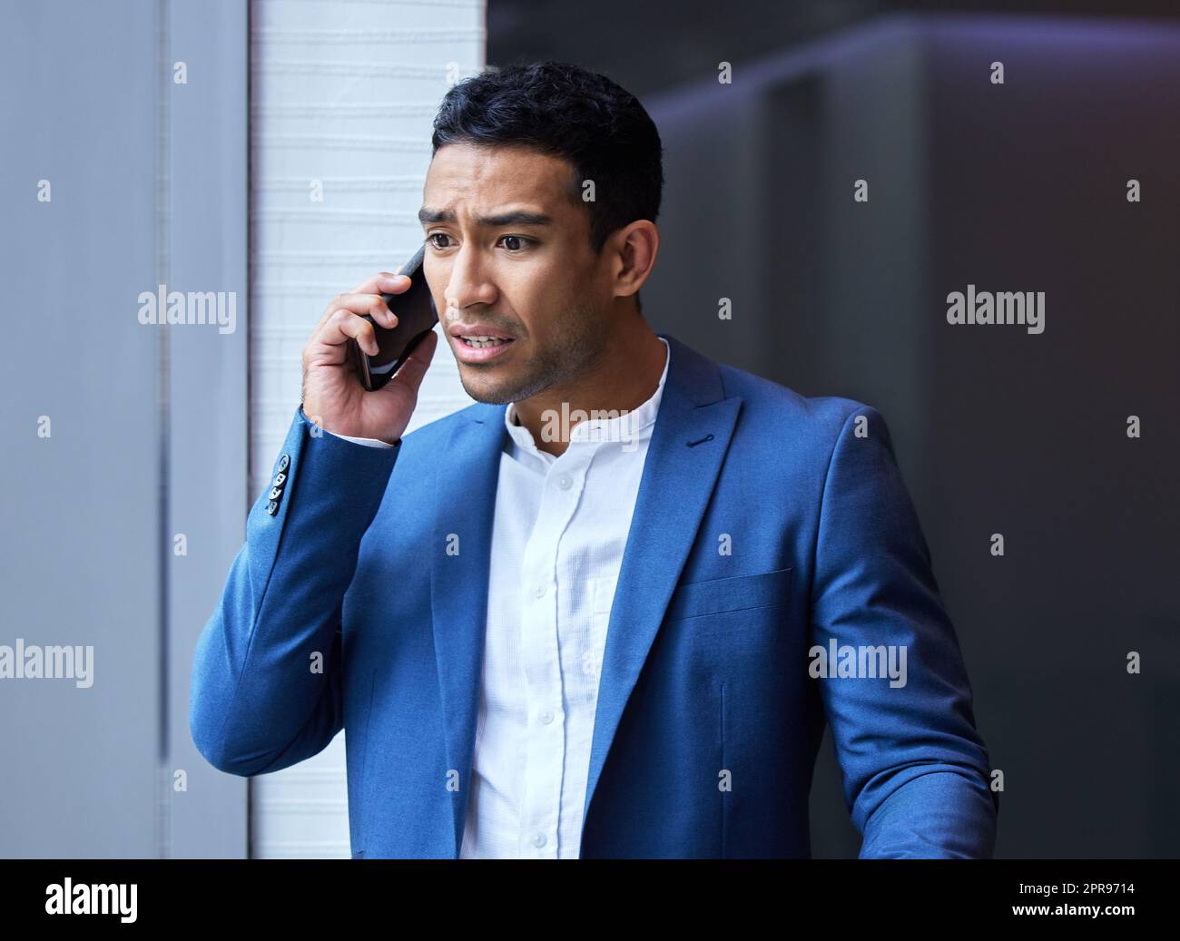Some of your greatest pains become your greatest strengths. a young man using his phone at work. Stock Photo
