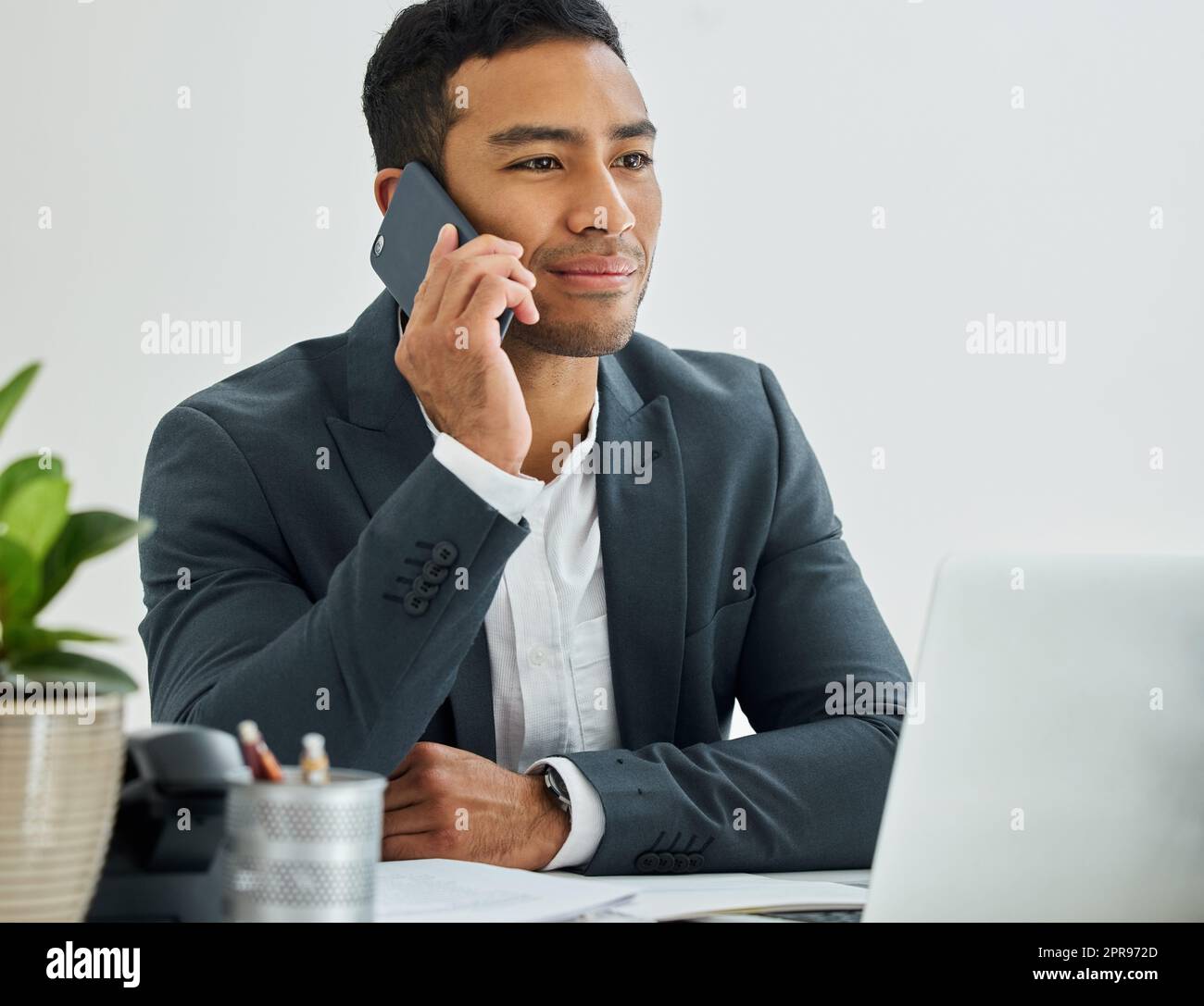 You forgot me, now the whole world know me. a businessman during a call on his smartphone at his desk in a modern office. Stock Photo