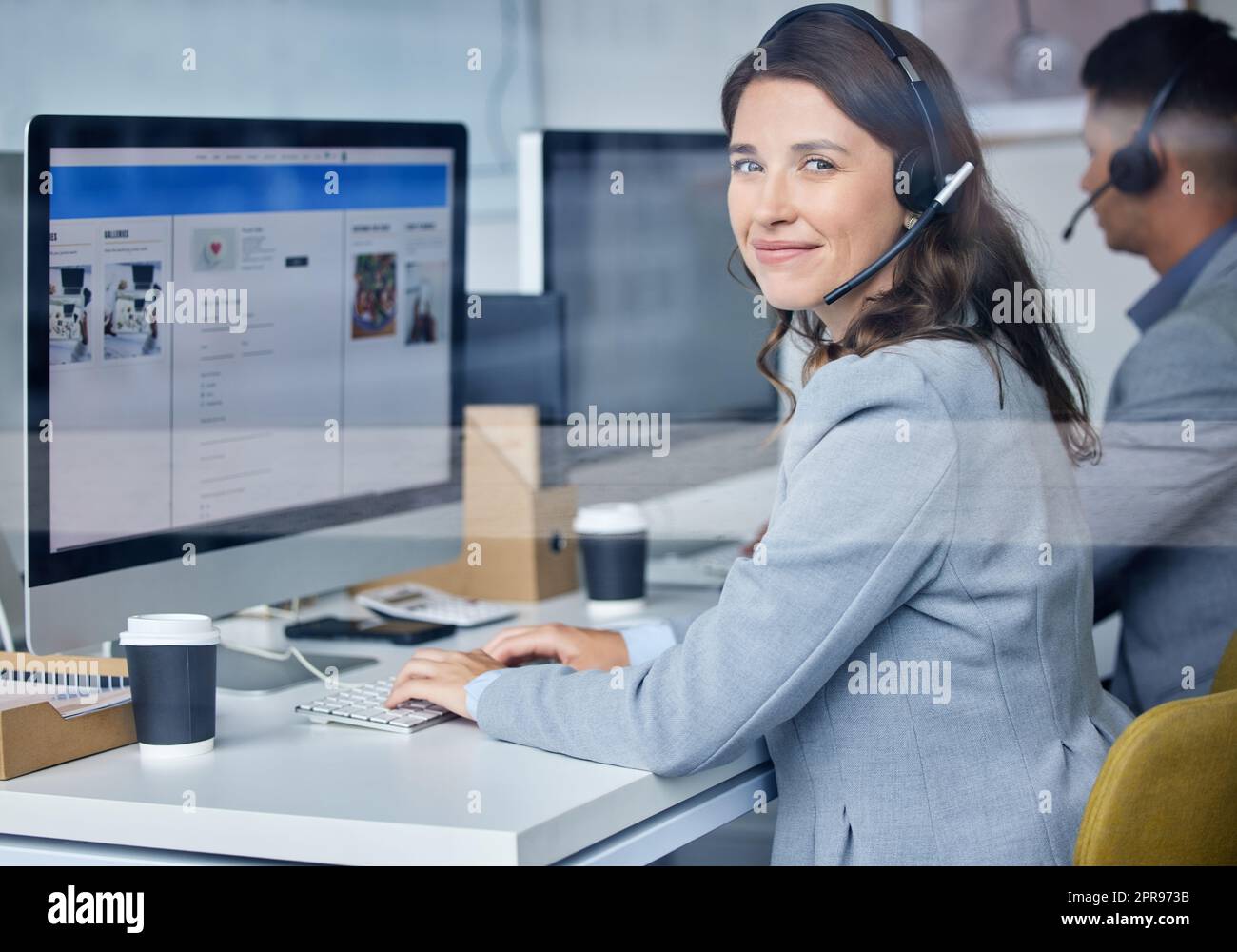 There will always be customers to help. Cropped portrait of an attractive young female call center agent working at her desk. Stock Photo