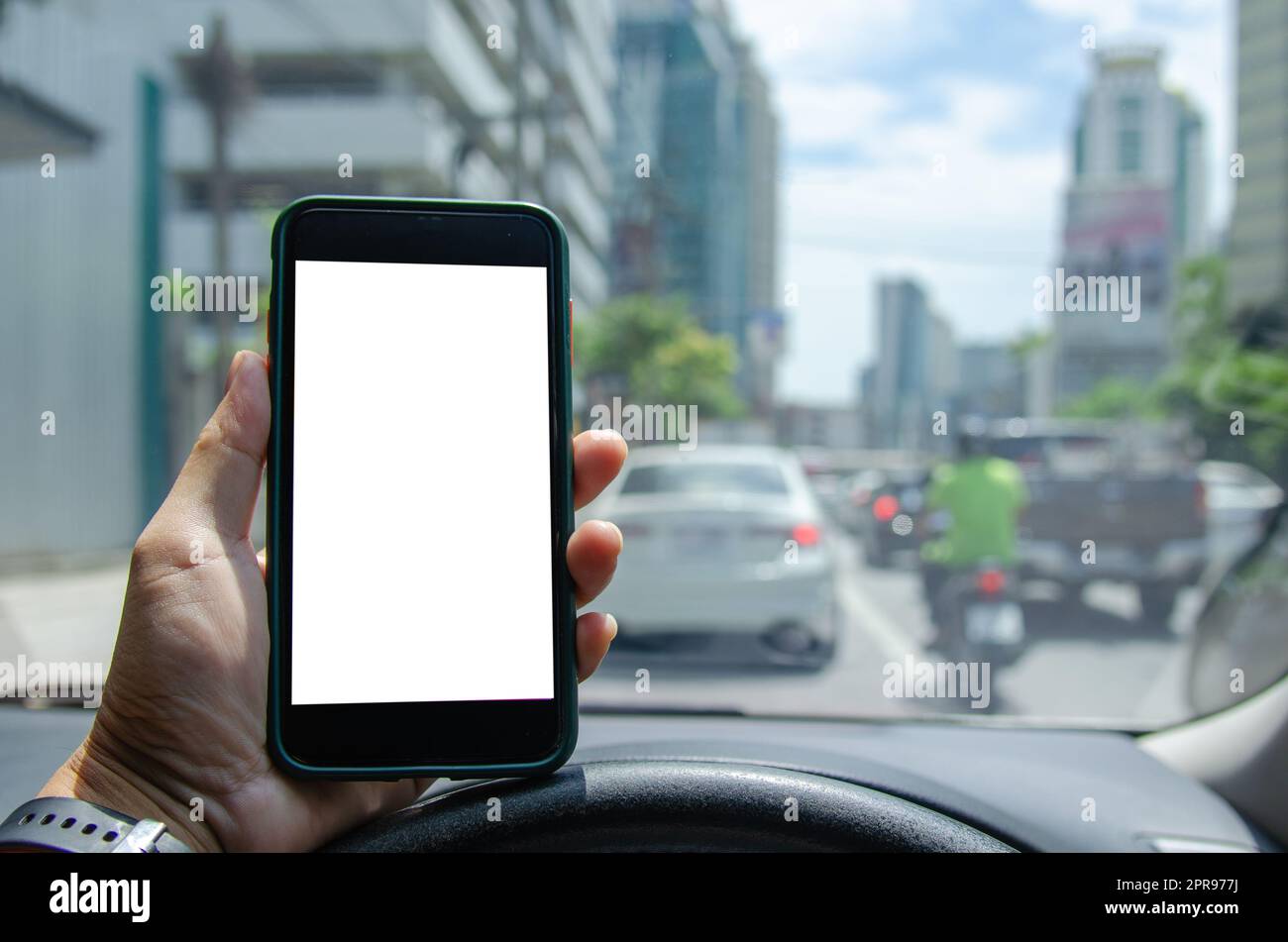 man holding mobile smartphone mock up white screen display in car. Stock Photo