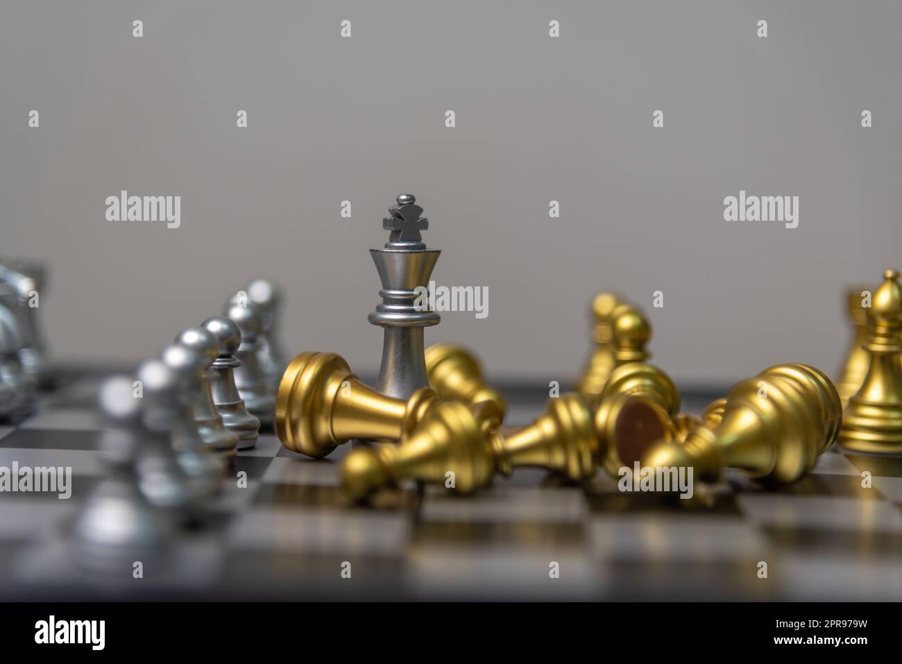 Premium Photo  Golden king chess standing with chess pieces lying