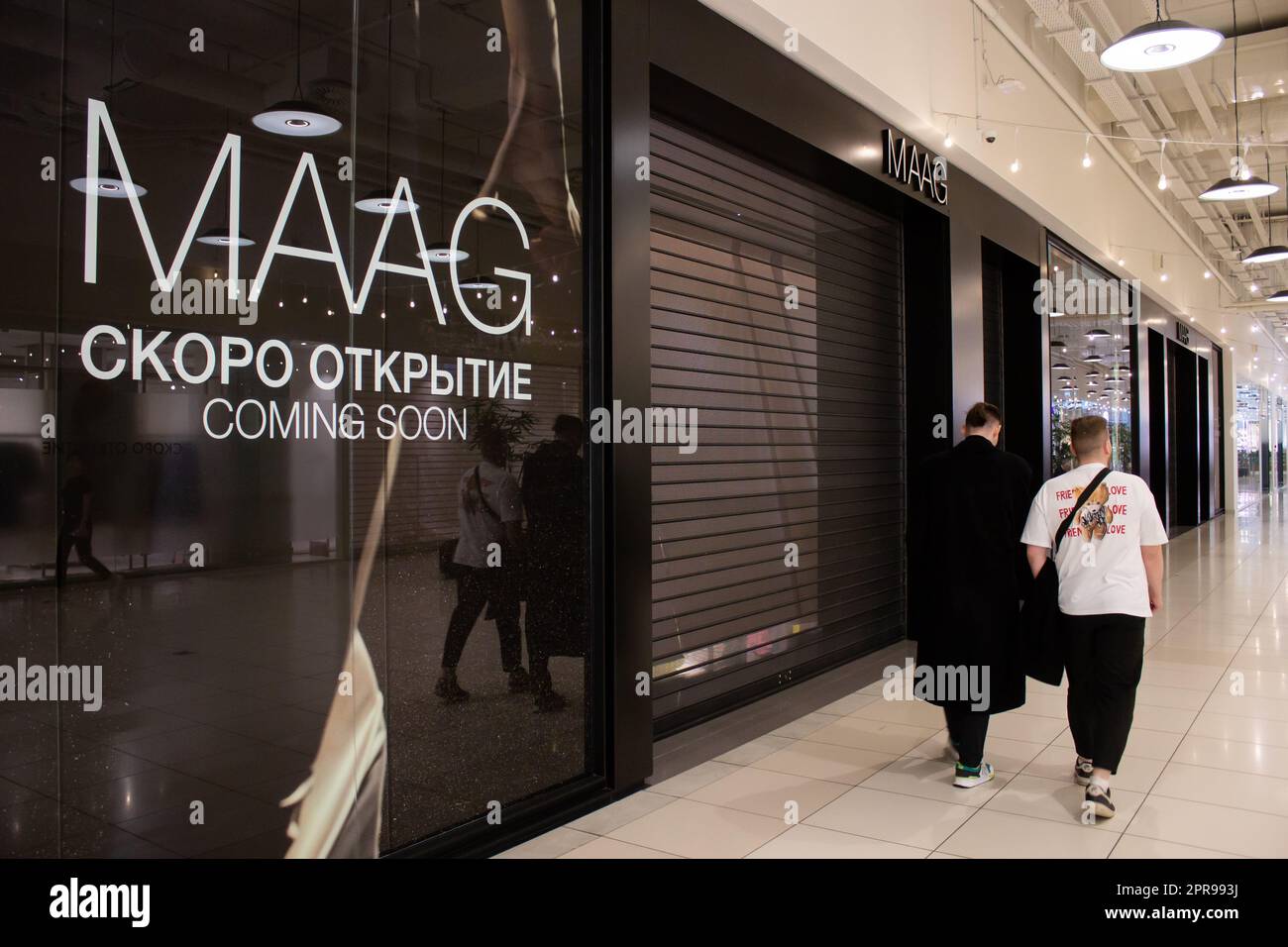 People walk past a new MAAG boutique in a shopping mall. Former Bershka  stores in Russia that used to belong to Spanish clothing conglomerate  Inditex are to reopen under a new name,
