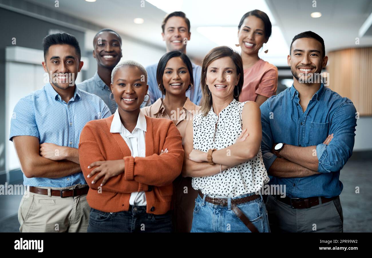 Out win the competition with confidence. Portrait of a group of confident young businesspeople working together in a modern office. Stock Photo
