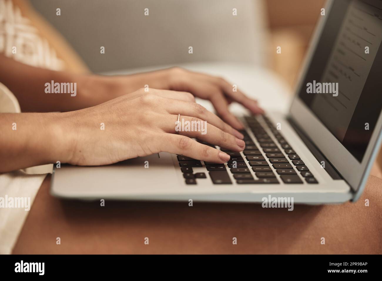 Time foe some house hunting. an unrecognizable person using a laptop at home. Stock Photo
