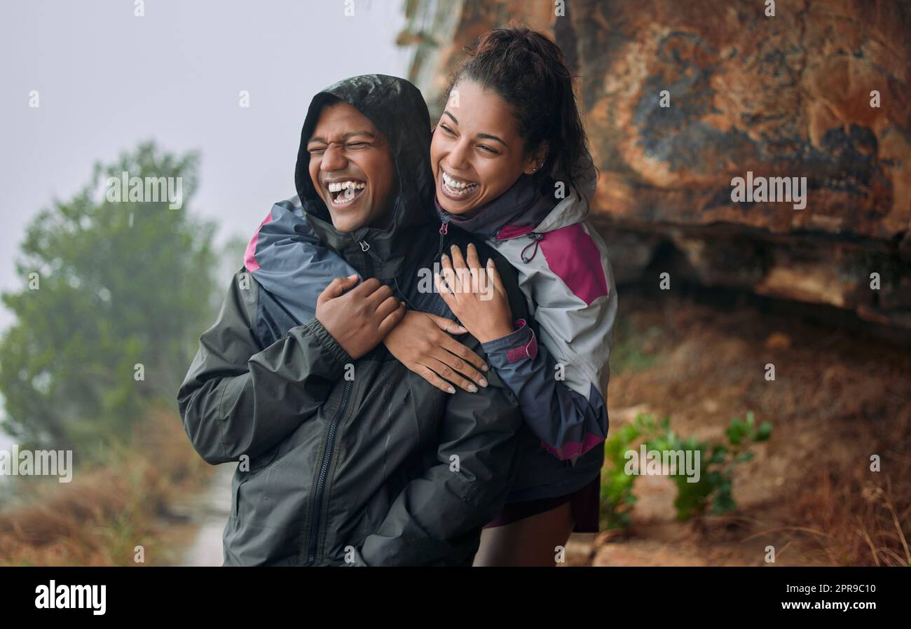 You are my sunshine on cloudy days. a young couple wearing their rain jackets while out hiking. Stock Photo