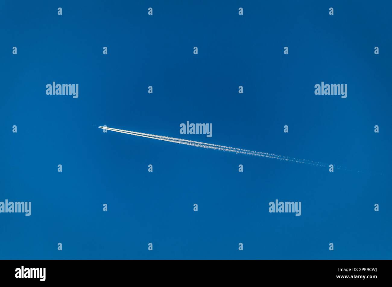 View of an airplane on blue sky background Stock Photo - Alamy