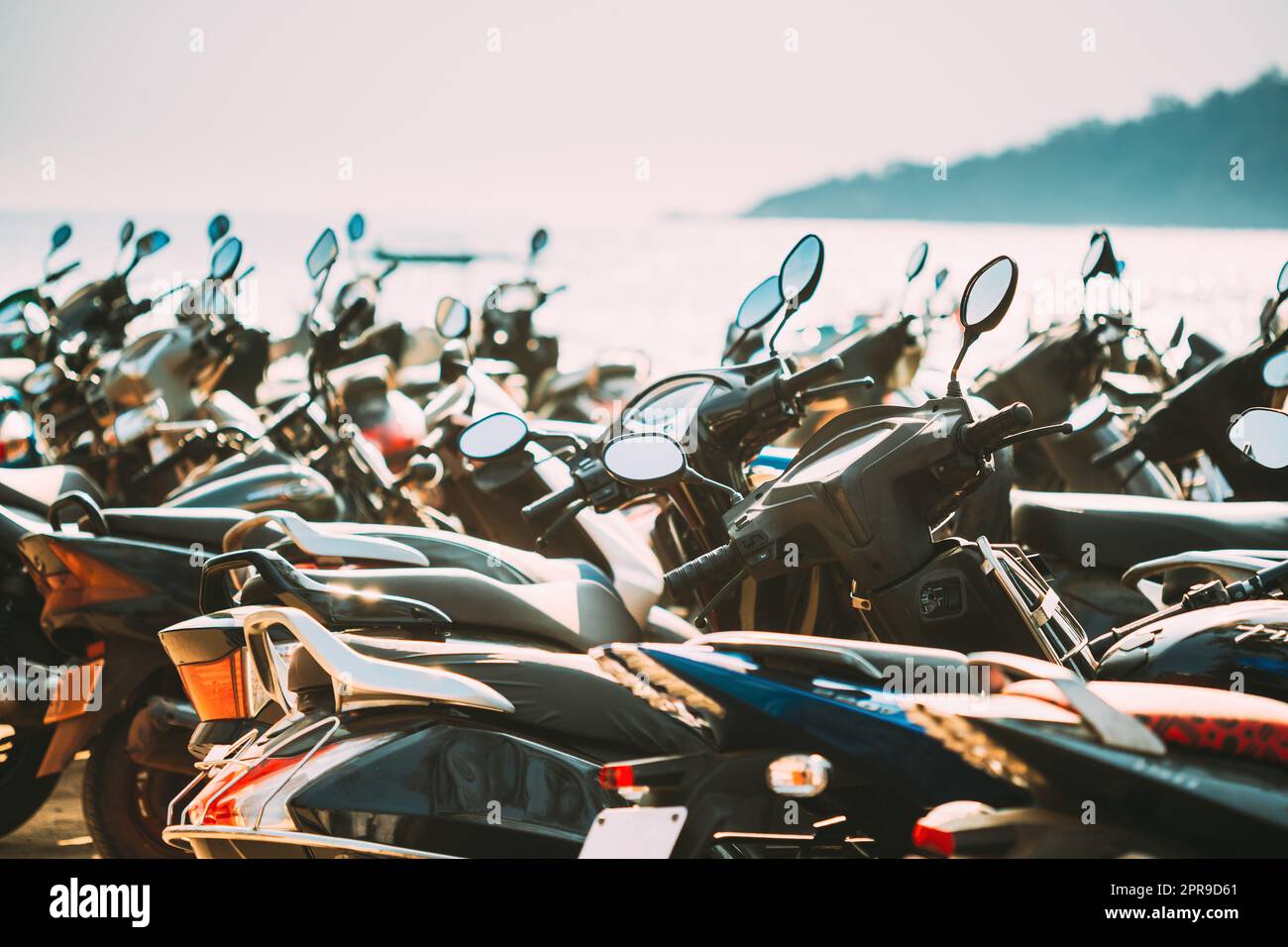 Motorbikes, motorcycles scooters parked in row in city street. Close up of details. Bikes Stock Photo