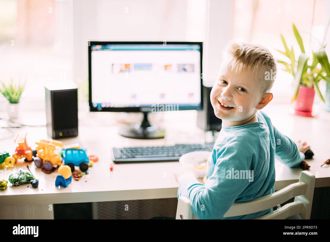 Little Caucasian Boy Playing In Computer Games Stock Photo