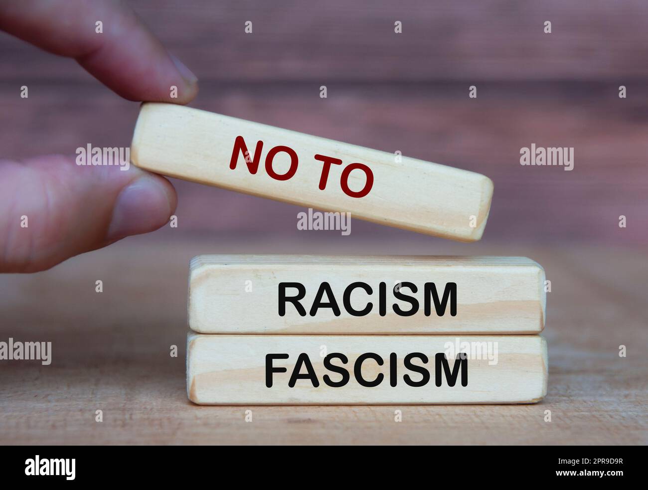 Hand holding no to racism and fascism. Rights protection culture concept Stock Photo