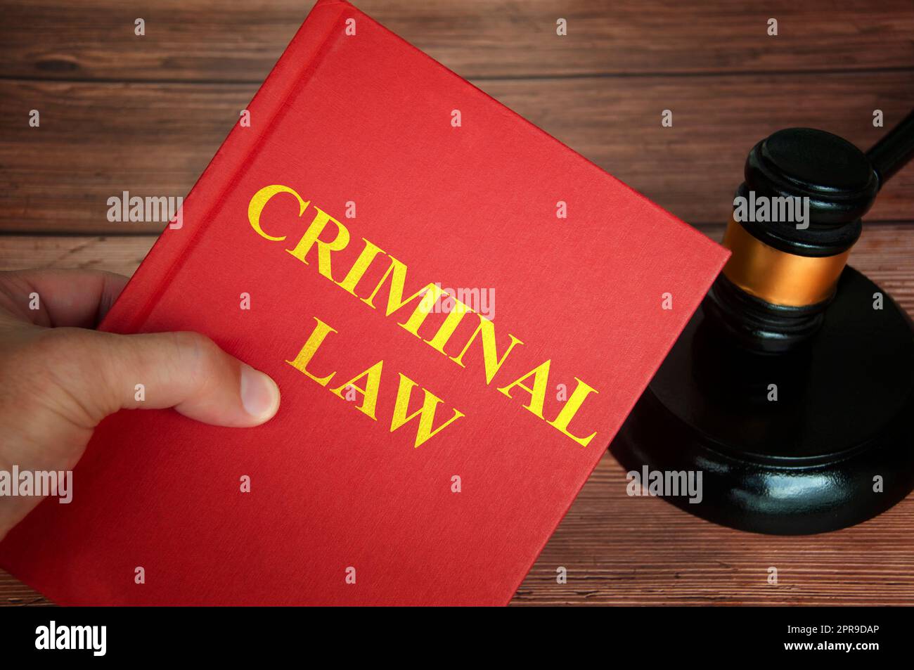 Criminal law text on law book with judge gavel on wooden desk background. Stock Photo
