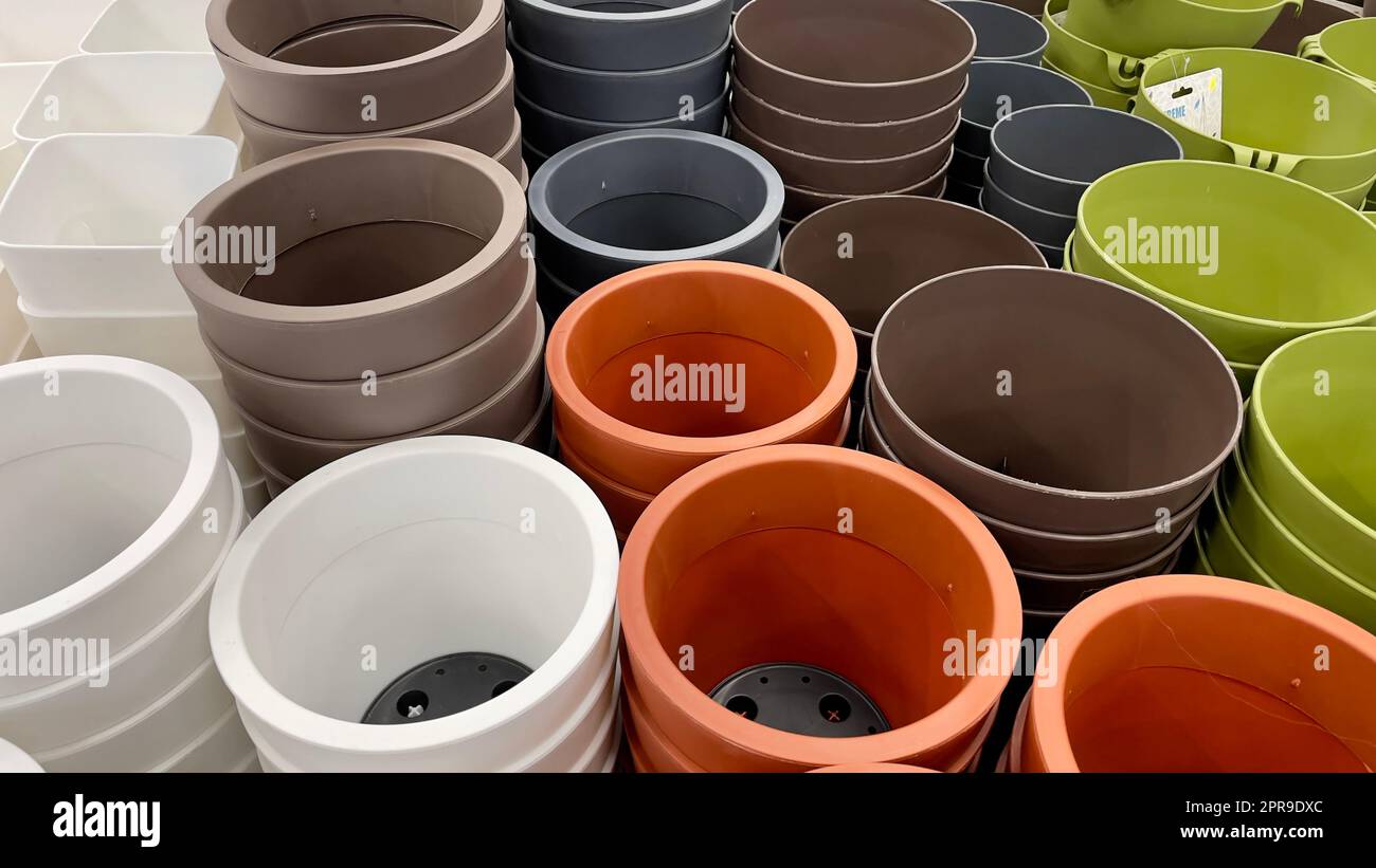 Close-up of empty flower pots in a store or greenhouse. Colorful pots ...