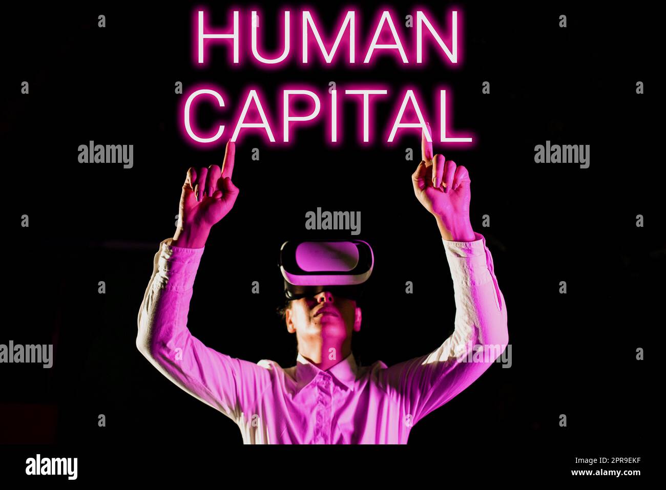 Hand writing sign Human Capital. Concept meaning Intangible Collective Resources Competence Capital Education Woman Taking Professional Training Through Virtual Reality Goggles. Stock Photo