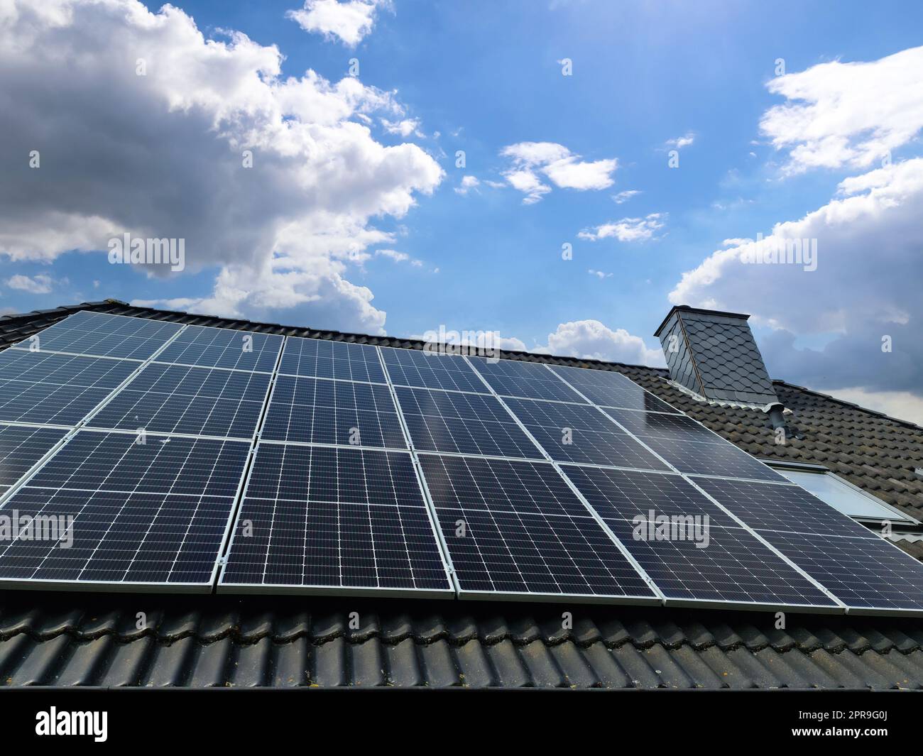 Solar panels producing clean energy on a roof of a residential house ...