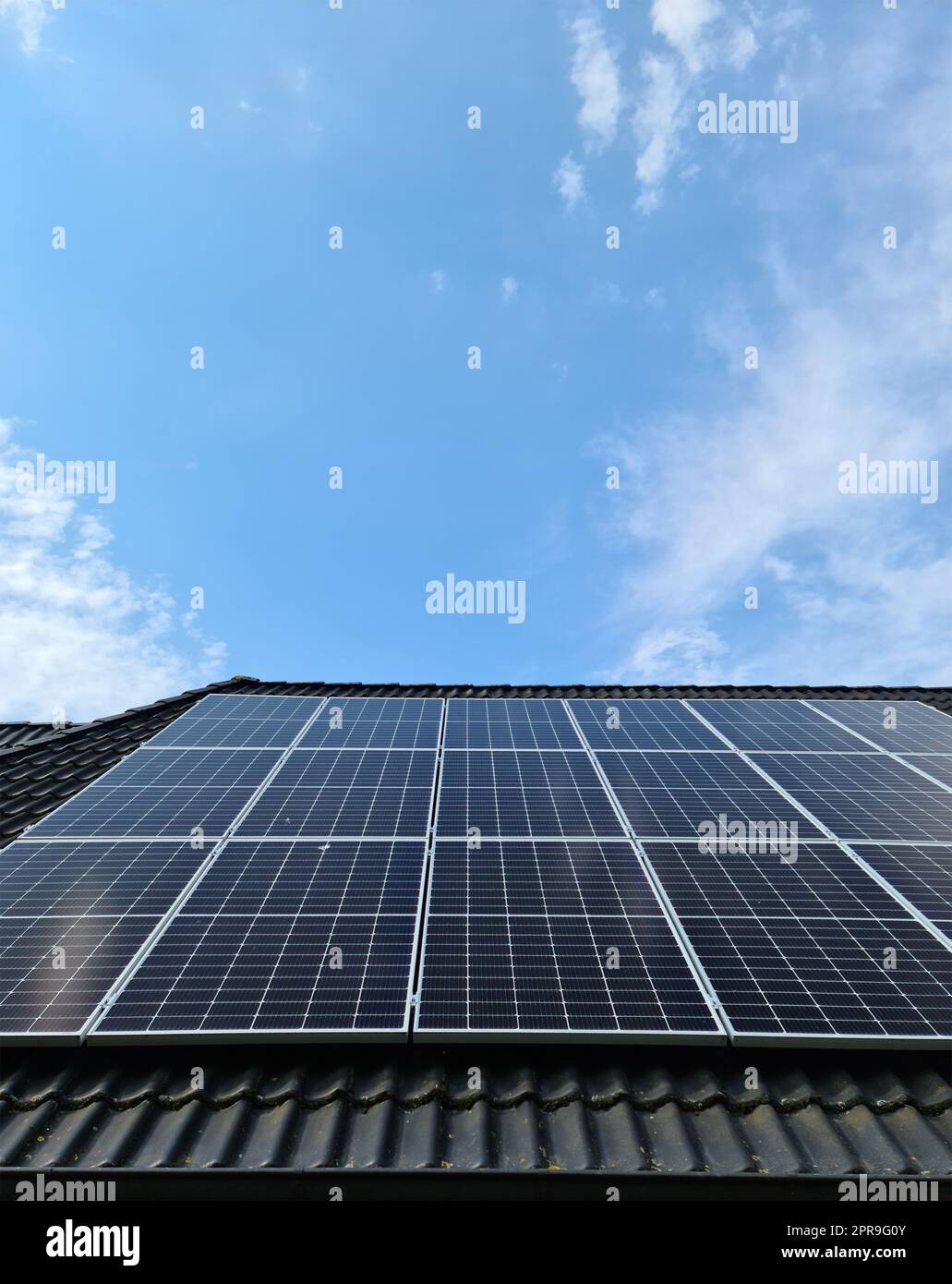 Solar panels producing clean energy on a roof of a residential house ...
