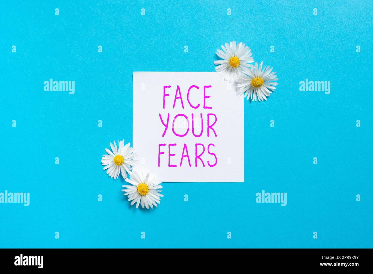 Text showing inspiration Face Your Fears. Internet Concept Have the courage to overcome anxiety be brave fearless Sticky Note With Important Messages With Flowers On Both Sides. Stock Photo