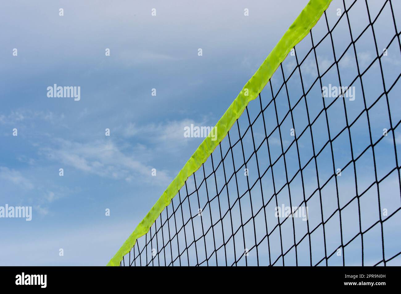 Beach volleyball and beach tennis net on blue sky background. Summer