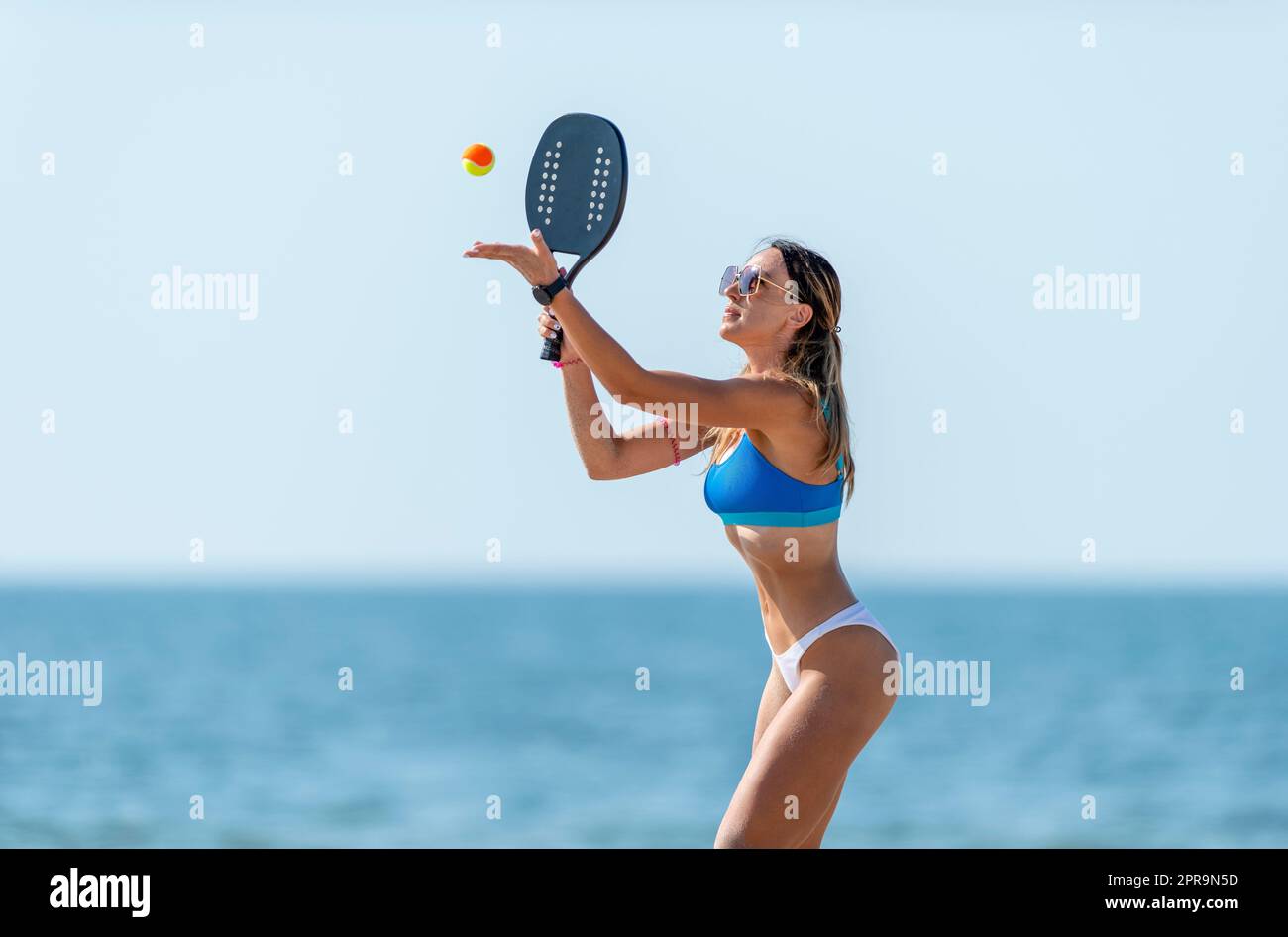 Woman playing beach tennis on a beach. Professional sport concept.  Horizontal sport theme poster, greeting cards, headers, website and app  Stock Photo - Alamy