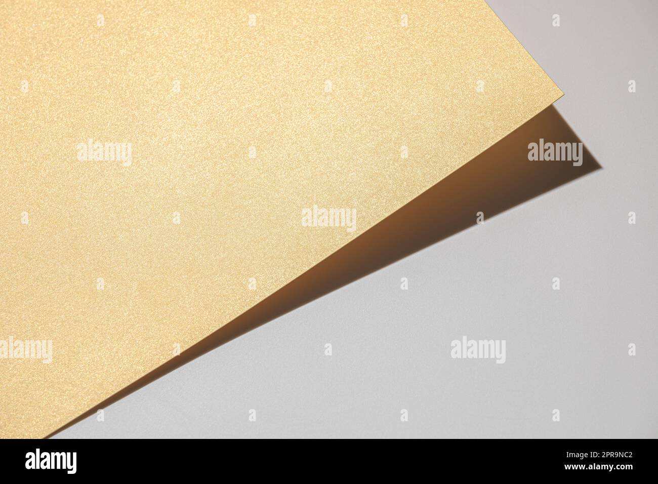 Golden cardbord on light gray background Stock Photo