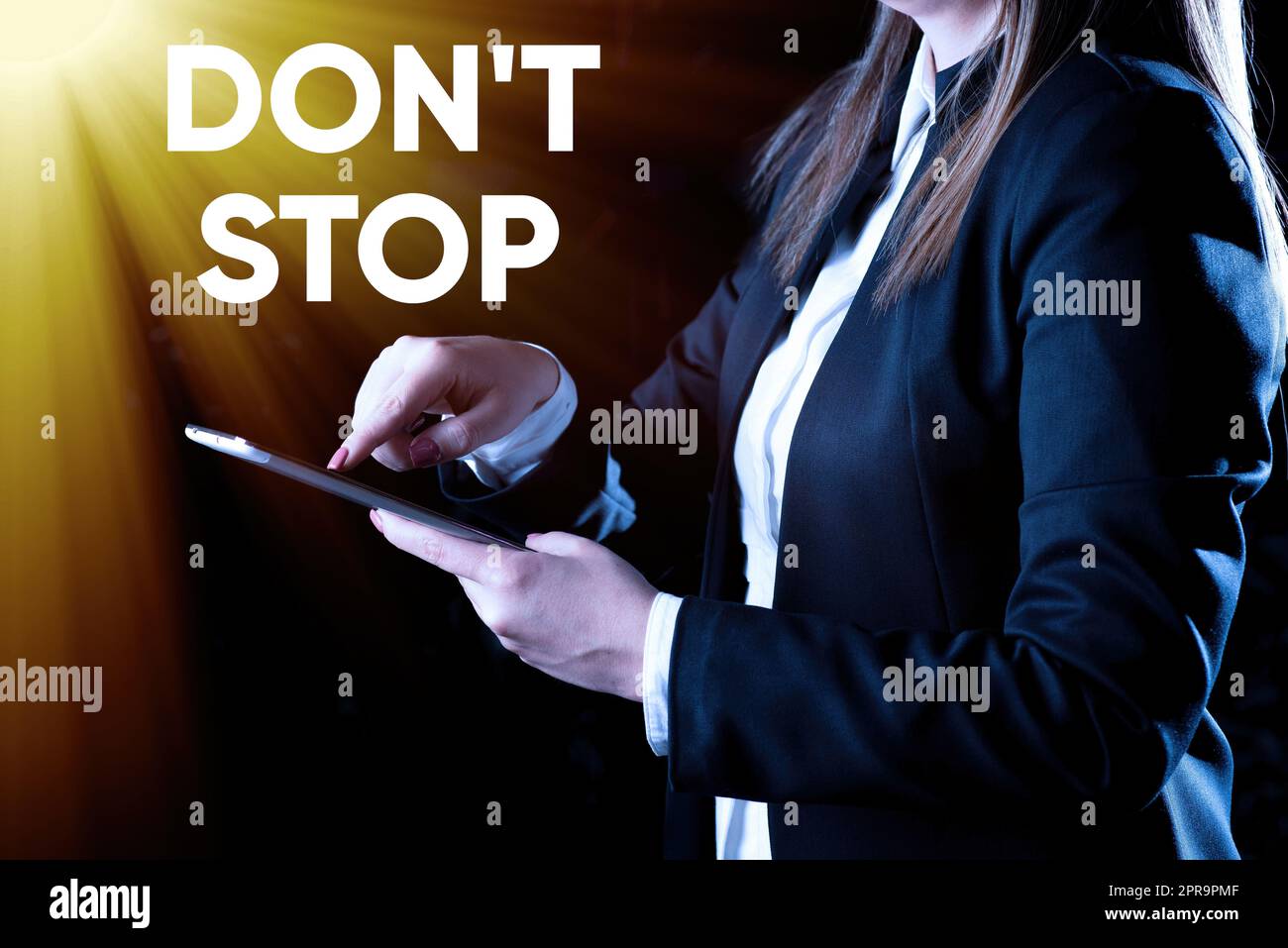 Hand writing sign Don T Not Stop. Business overview Continue what had been doing without rendering a delay Businesswoman Holding Tablet In One Hand And Pressing On It. Stock Photo