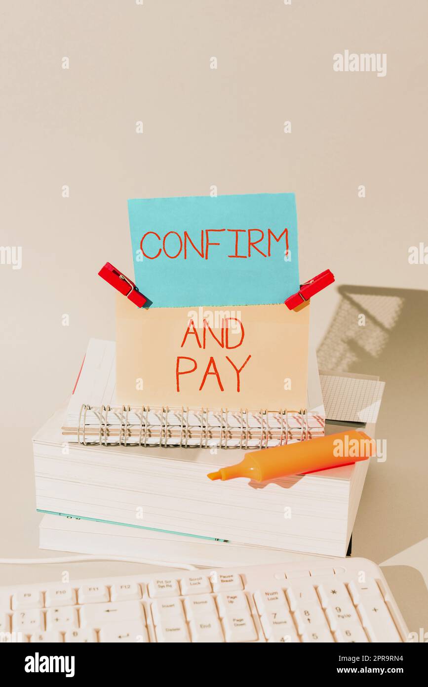 Conceptual caption Confirm And Pay. Business showcase Check out your purchases and make a payment Confirmation Important Messages Presented On Piece Of Paper On Desk With Books. Stock Photo