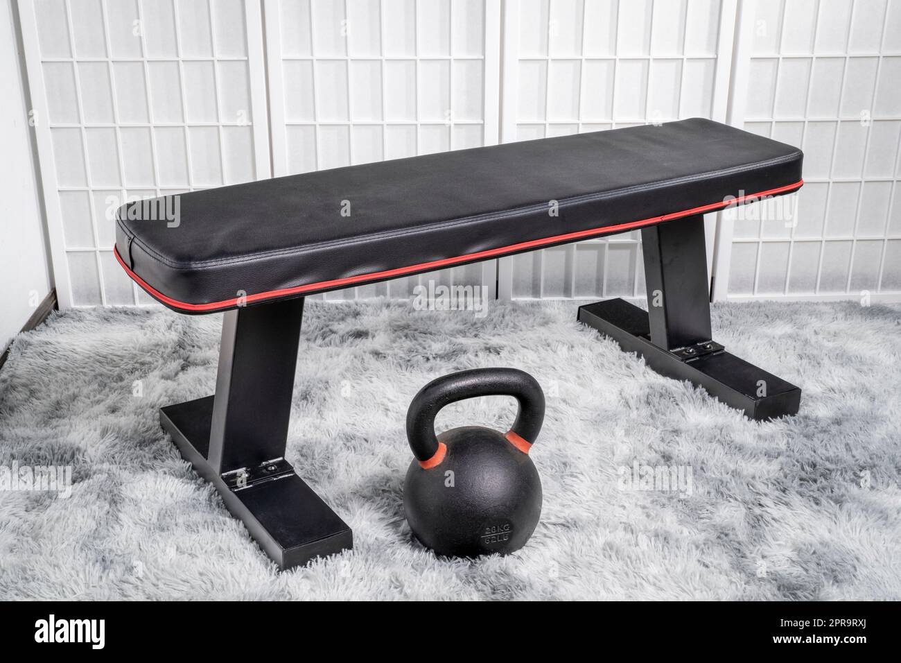 heavy iron kettlebell and exercise bench in a home gym fitness concept Stock Photo Alamy