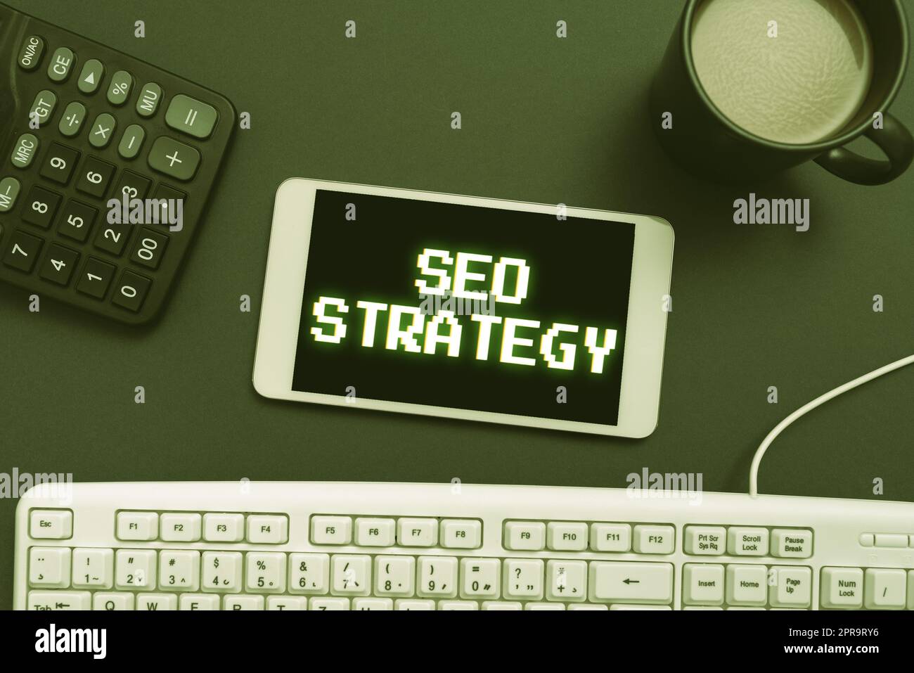 Conceptual caption Seo Strategy. Word Written on Techniques and tactics to increase the visitors of a website Cellphone With New Message On Desk With Keyboard, Calculator And Coffee. Stock Photo