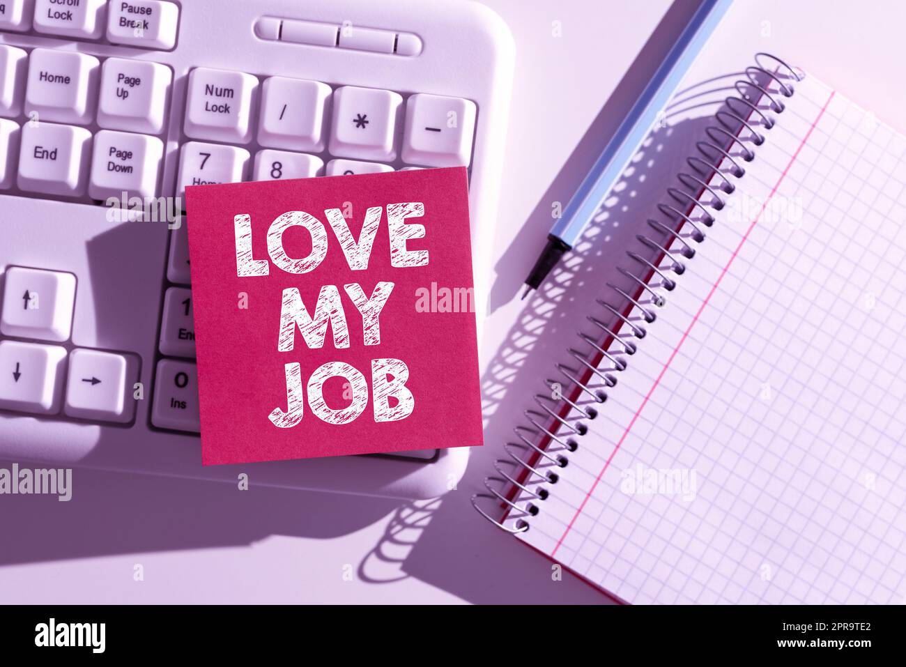 Hand writing sign Love My Job. Internet Concept To be pleased with the work that one does being comfortable Important Messages Written On Note On Desk With Pen, Notebook And Keyboard. Stock Photo