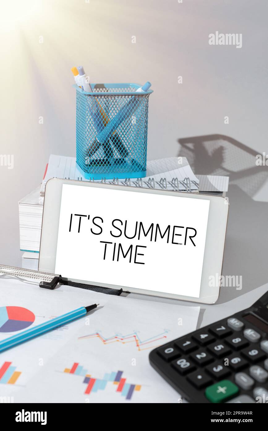 Hand writing sign It S Summer Time. Business overview Relax sunny hot season of the year Vacation beach trip Important Idea Shown On Phone On Desk With Cup With Pencils And Books. Stock Photo