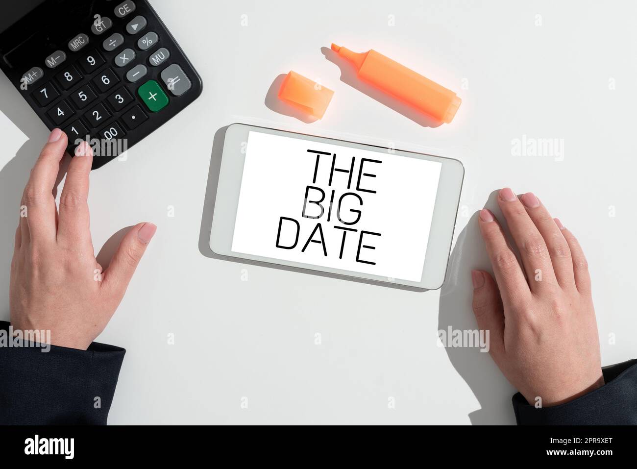 Conceptual caption The Big Date. Business overview Important day for a couple relationship wedding anniversary Woman Presenting New Ideas On Tablet On Desk With Marker And Calculator. Stock Photo