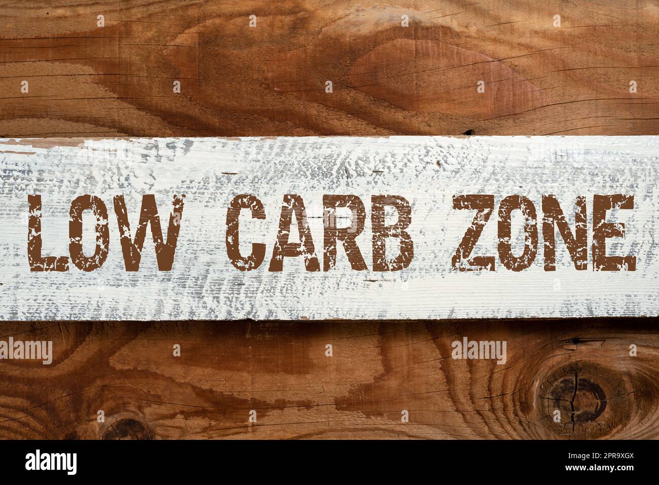 Conceptual display Low Carb Zone. Internet Concept Healthy diet for losing weight eating more proteins sugar free Important Informations Written On Piece Of Wood On Floor. Stock Photo