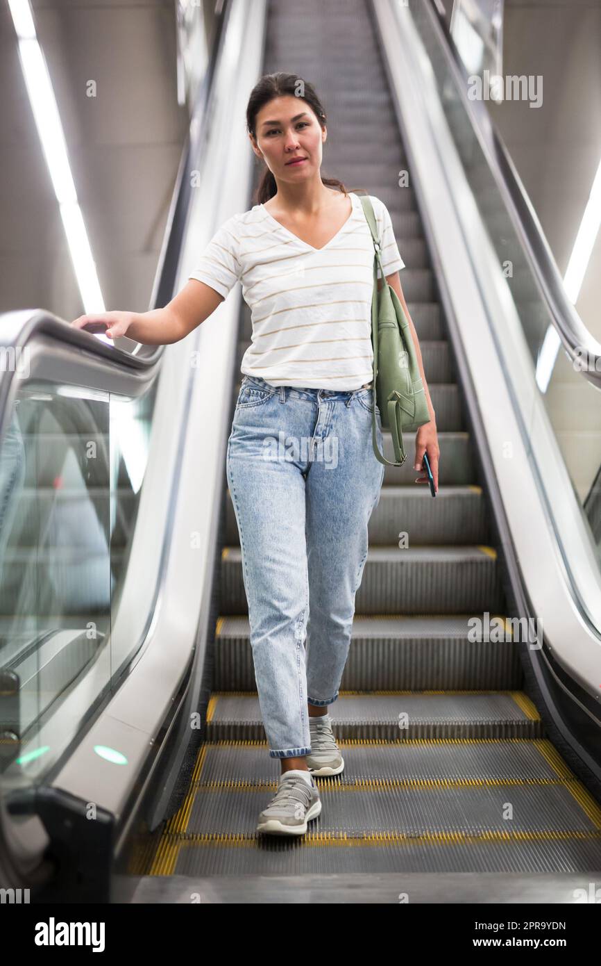 woman-going-through-escalator-stock-photo-alamy