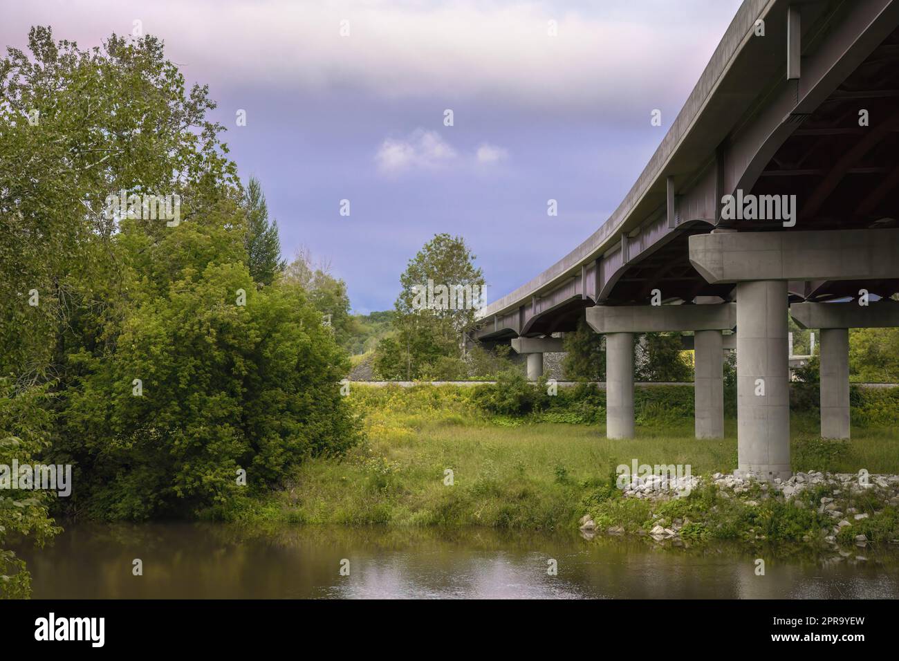 environment and transportation bridge river landscape trees and water reflections Stock Photo