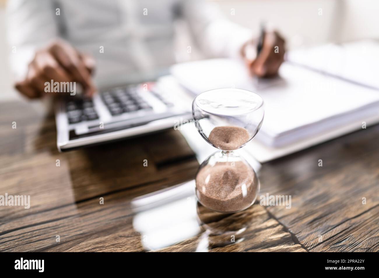 Late Invoice And Billing Deadline With Hourglass Stock Photo