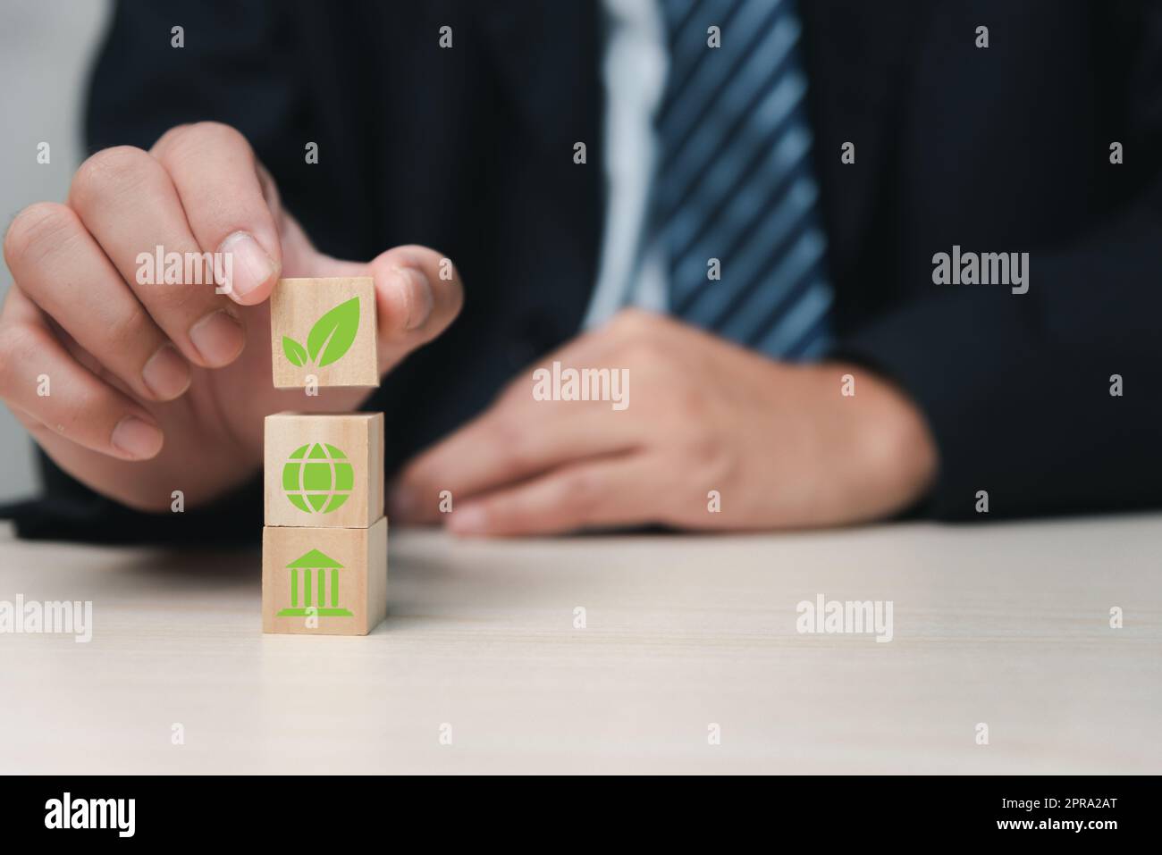 ESG environmental social governance eco green development industrial notion is held in the hands of a businessman. Stock Photo