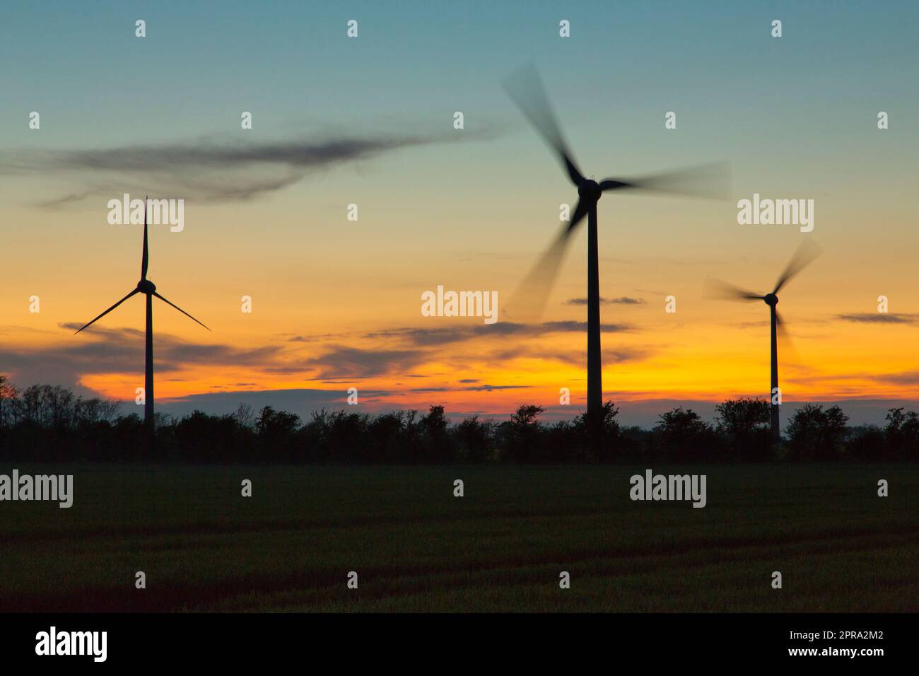 turning windwheels during sunset Stock Photo