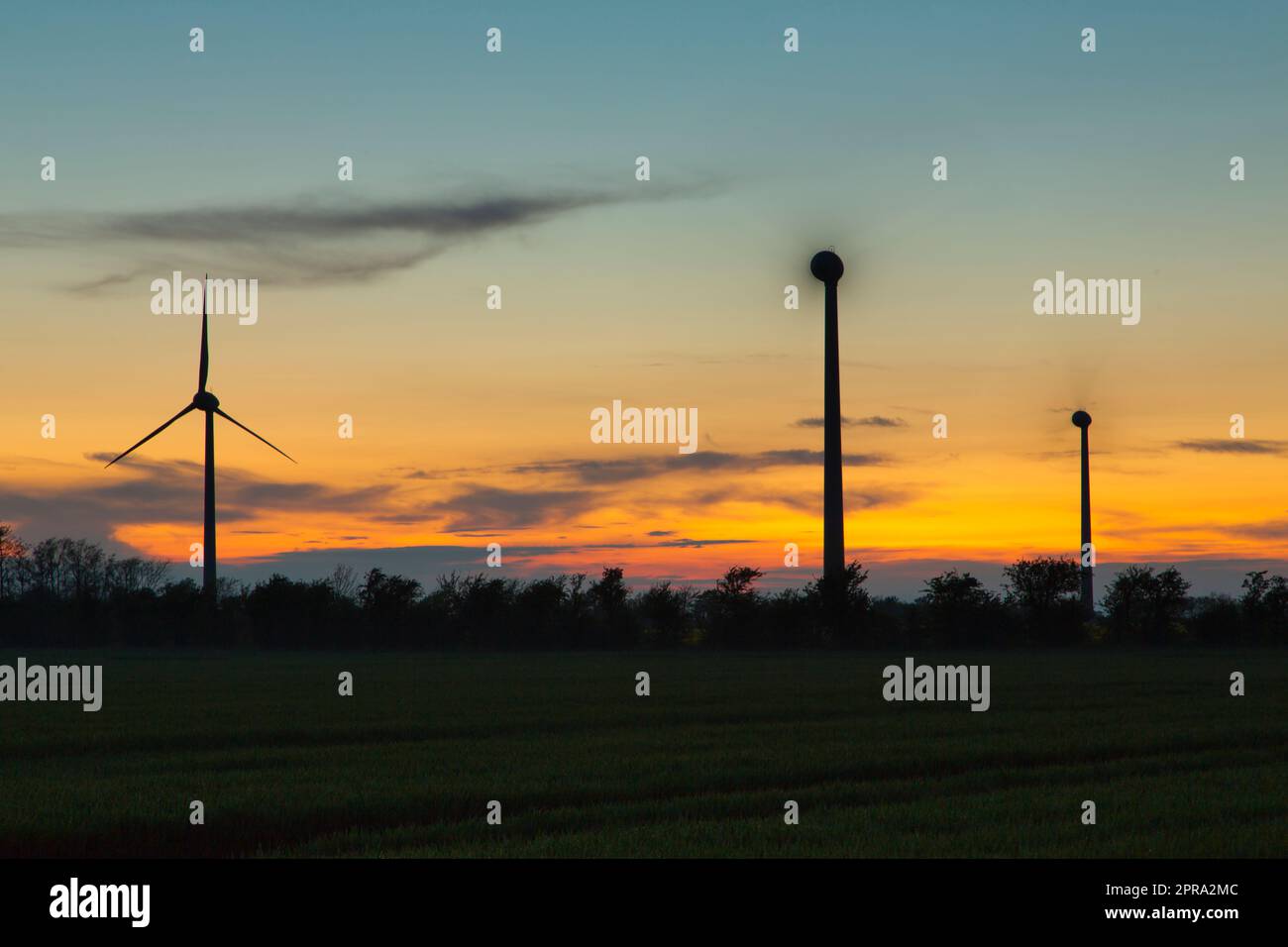 turning windwheels during sunset Stock Photo