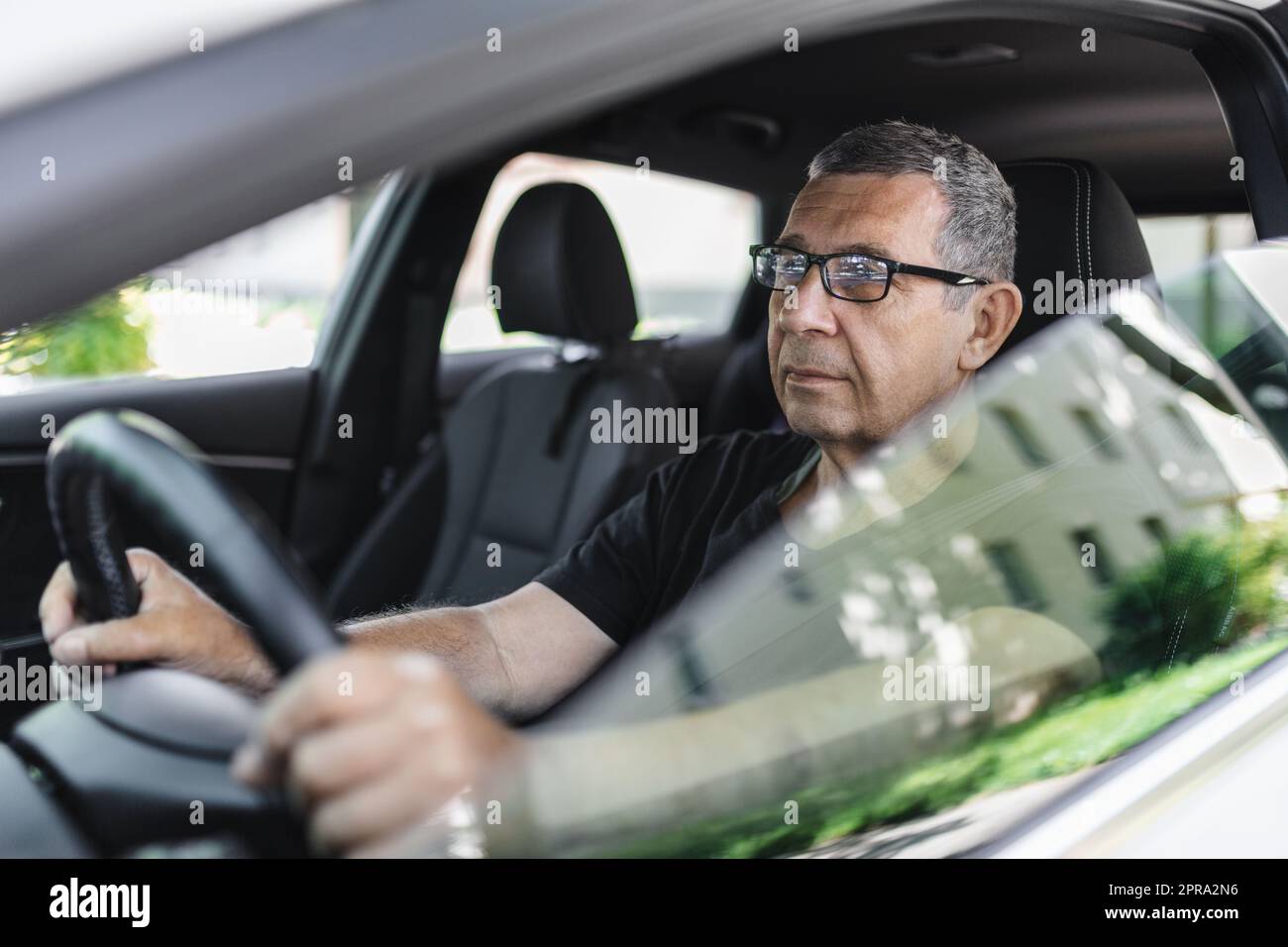 Senior in his 70s driving a car Stock Photo - Alamy