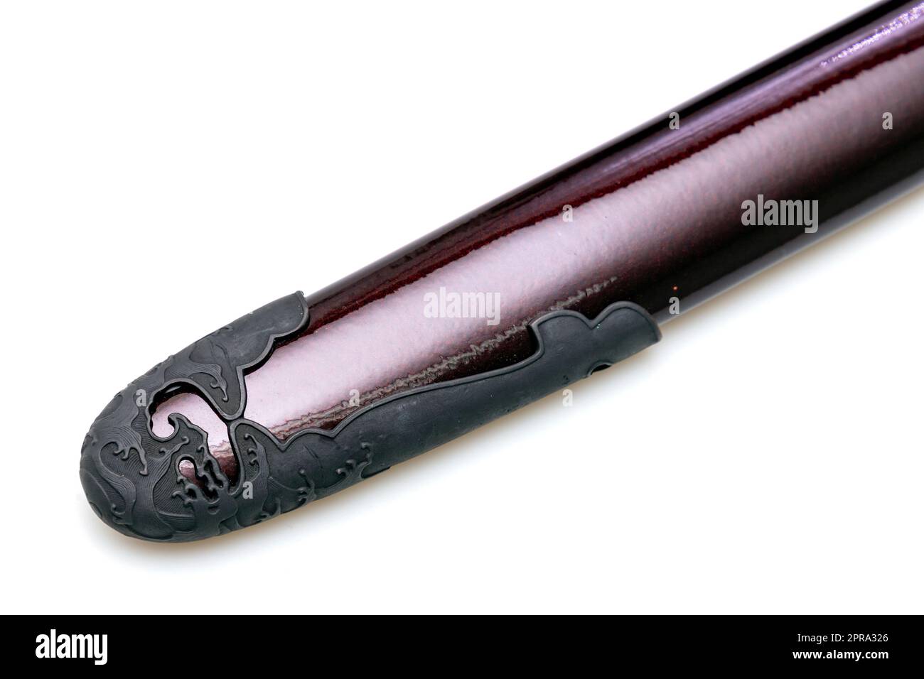 'Kojiri' is the end of the Japanese sword's scabbard or the protective fitting at the end of the scabbard. Normally made by horn but in this picture is metal. Isolated in white Background. Stock Photo