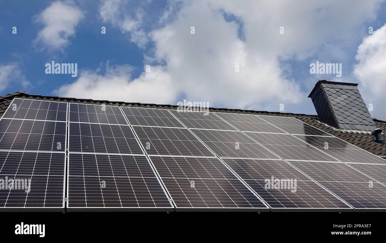 Solar panels producing clean energy on a roof of a residential house ...