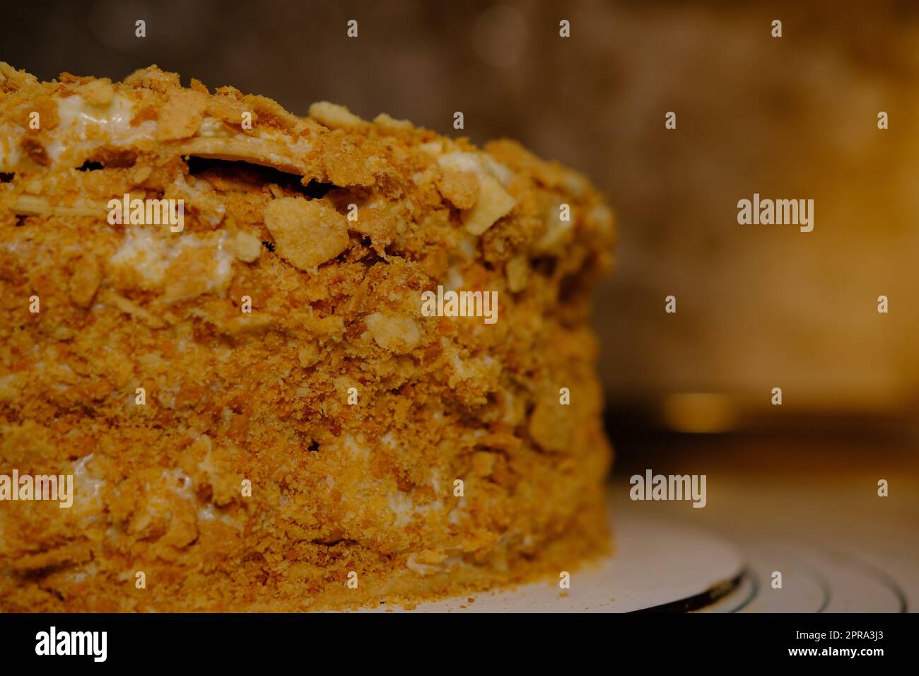 Board with delicious Napoleon cake, close up with selective blur Stock Photo