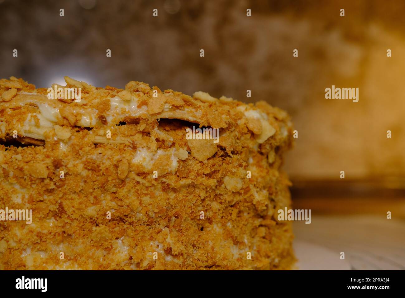 Board with delicious Napoleon cake, close up with selective blur Stock Photo