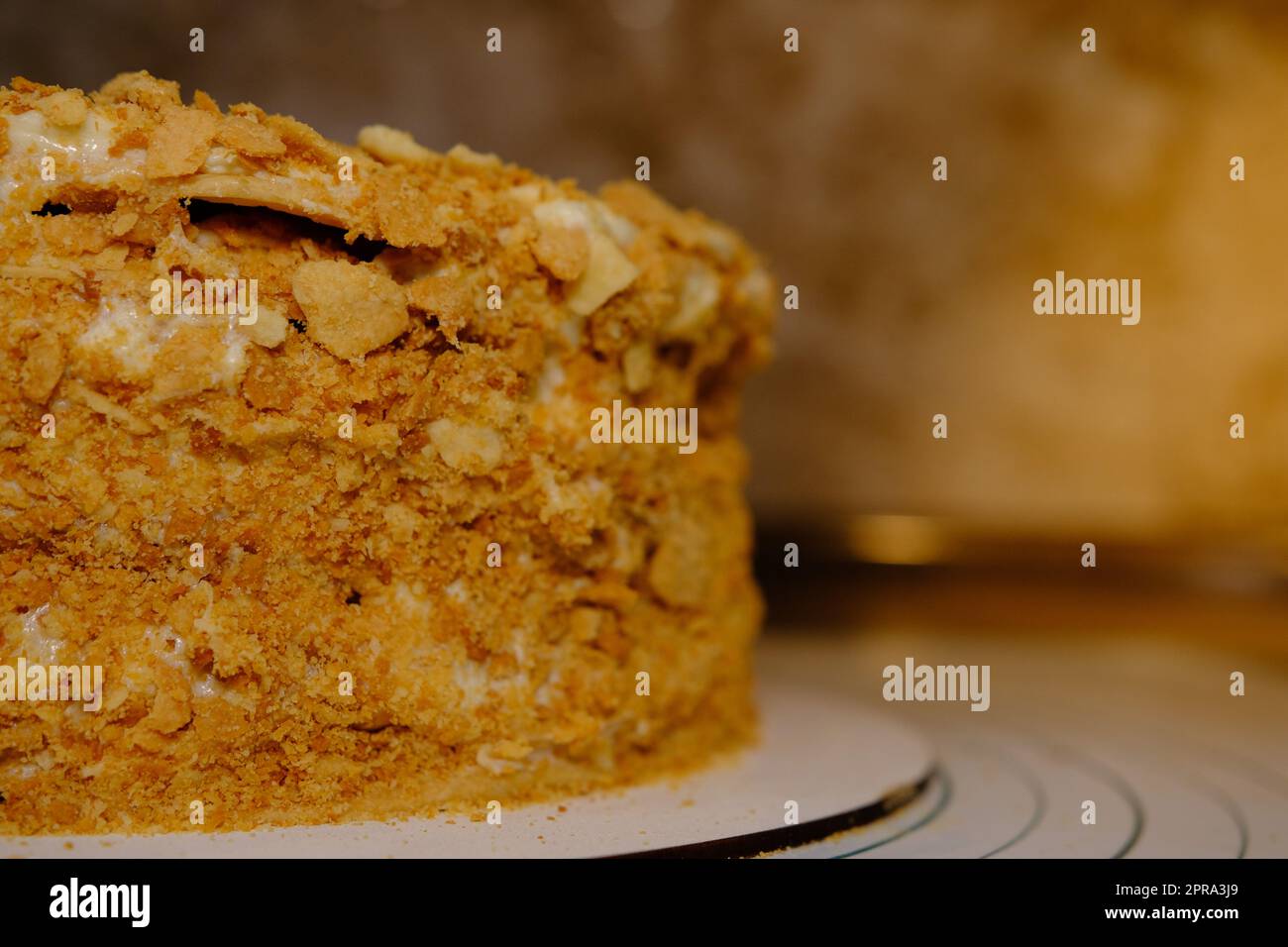 Board with delicious Napoleon cake, close up with selective blur Stock Photo