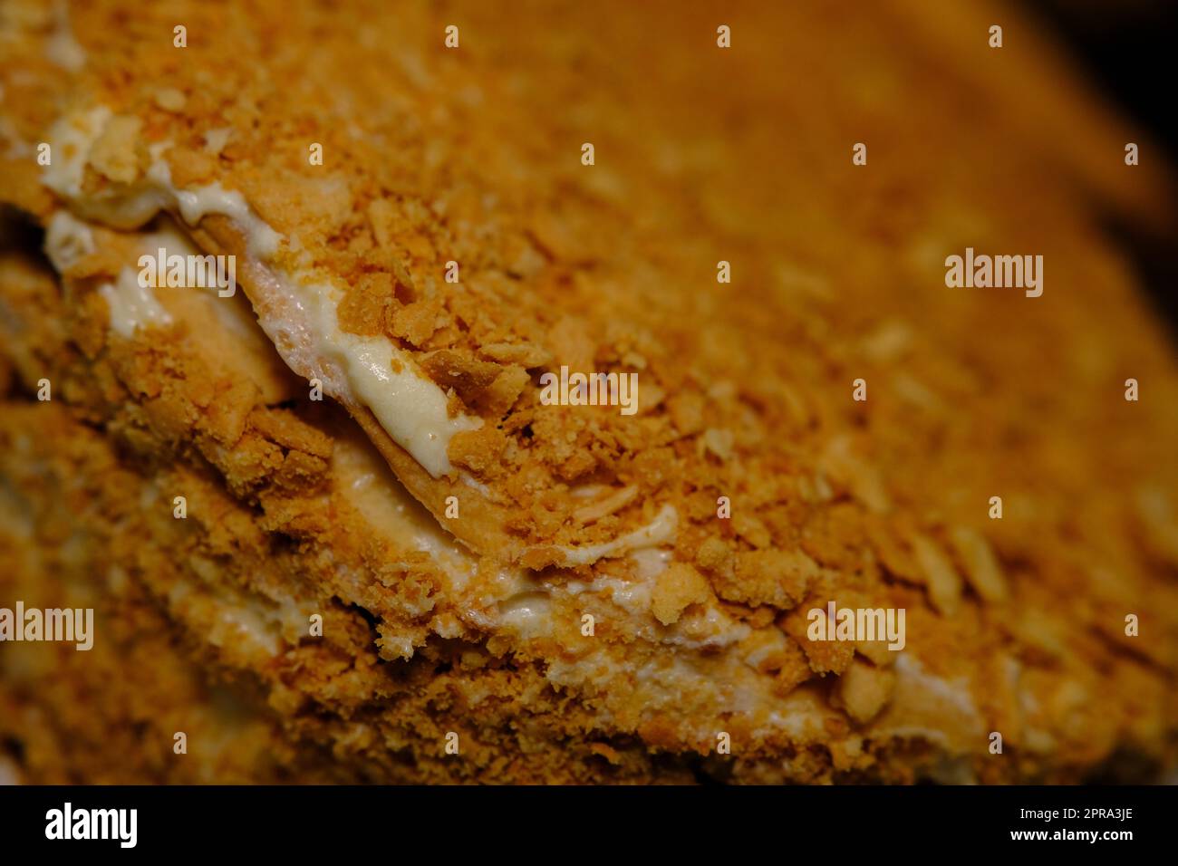 Board with delicious Napoleon cake, close up with selective blur Stock Photo
