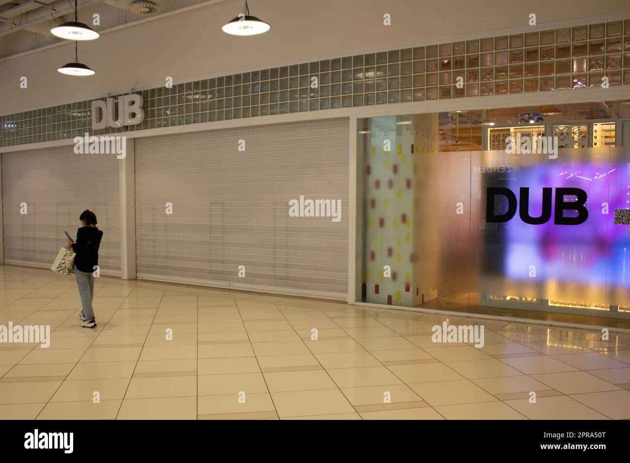 Moscow, Russia. 26th Apr, 2023. A woman walks past a new DUB boutique in a  shopping mall. Former Bershka stores in Russia that used to belong to  Spanish clothing conglomerate Inditex are