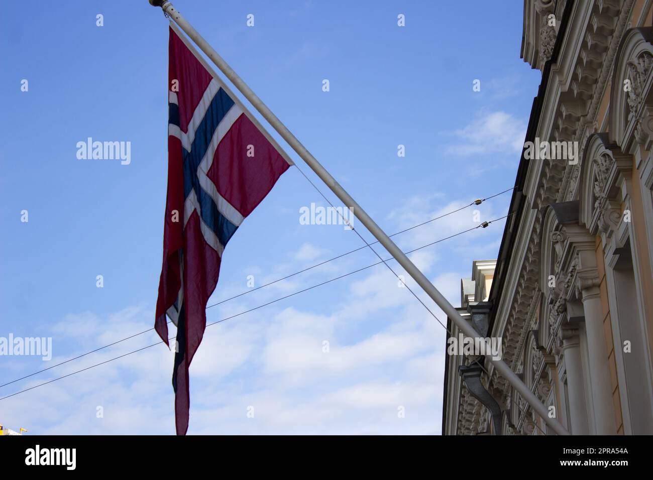 The national flag of Norway is seen above the embassy of the Kingdom of Norway in Moscow. Russia has made a decision to expel ten diplomats from Norway's Moscow embassy, according to the Russian Foreign Ministry. The decision followed the announcement on April 13 2023 that the Norwegian authorities had expelled 15 Russian embassy officials. Stock Photo