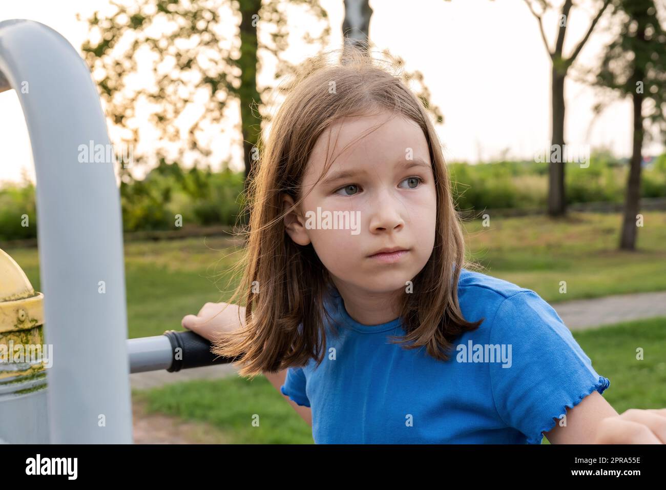 Elementary school age child on a playground outdoors, simple natural