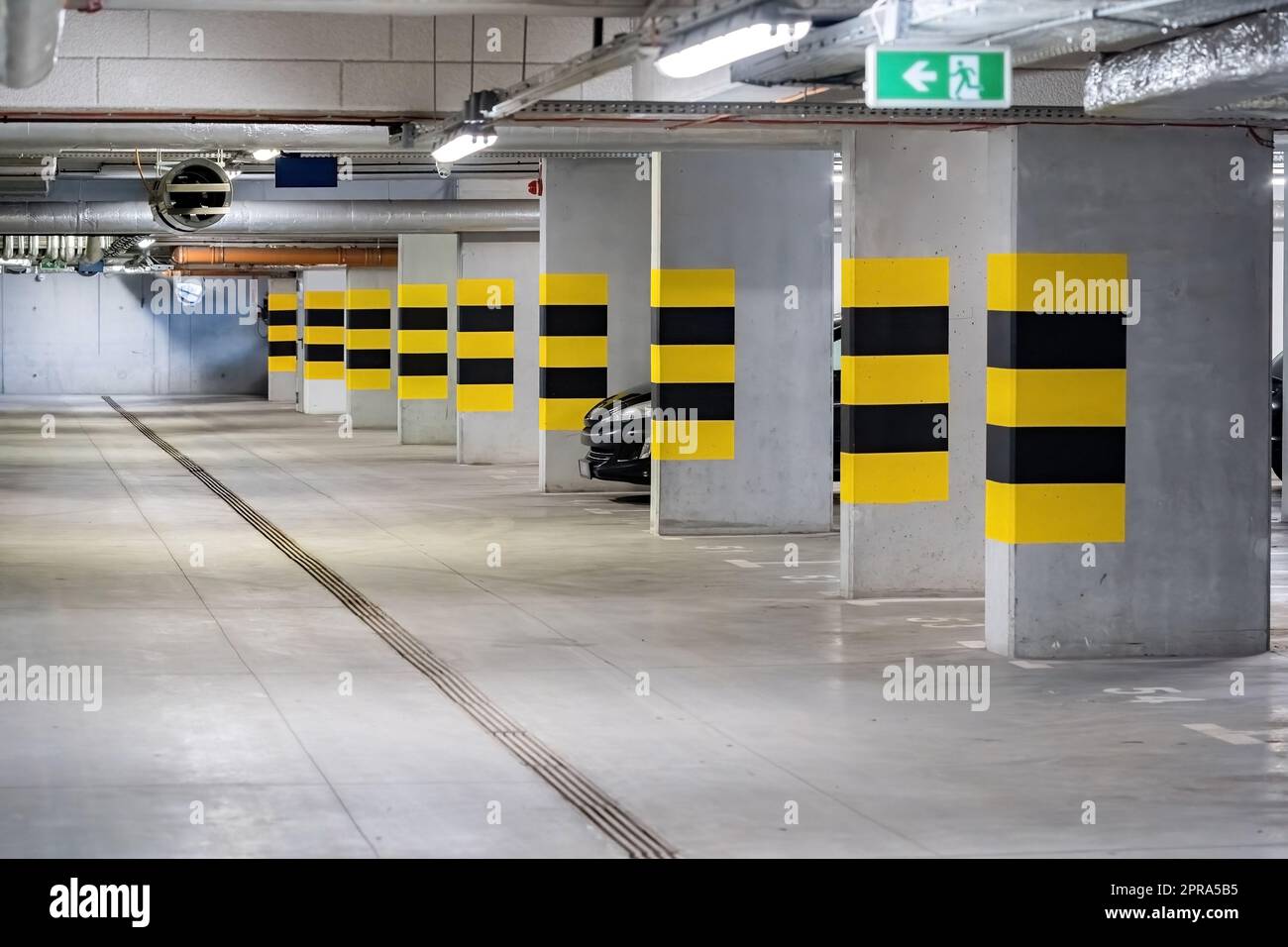 Empty underground parking lot under a modern apartment complex flat