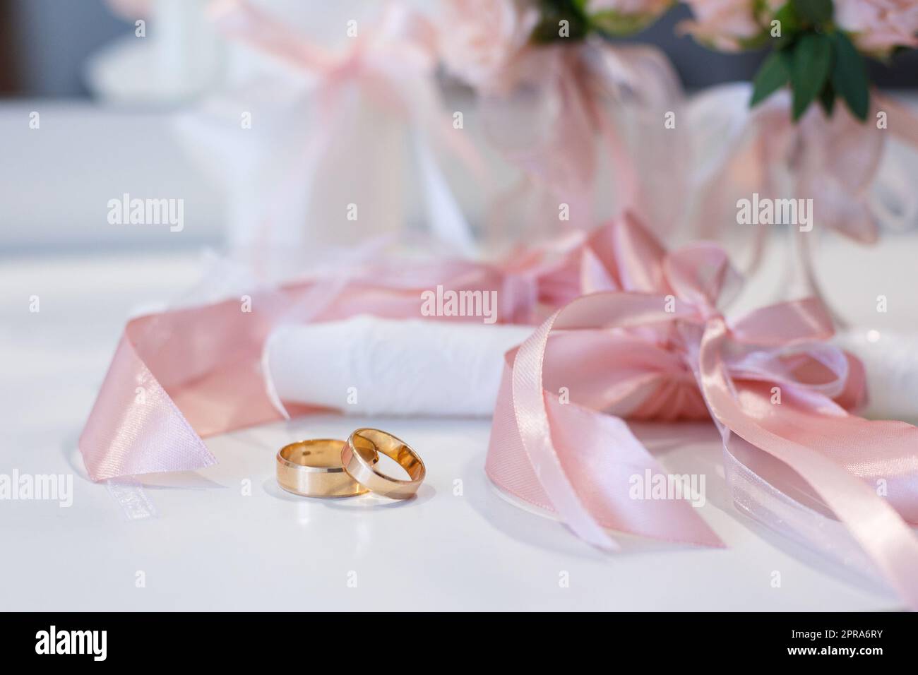Close up of gold universal wedding rings lying on the table. Stock Photo
