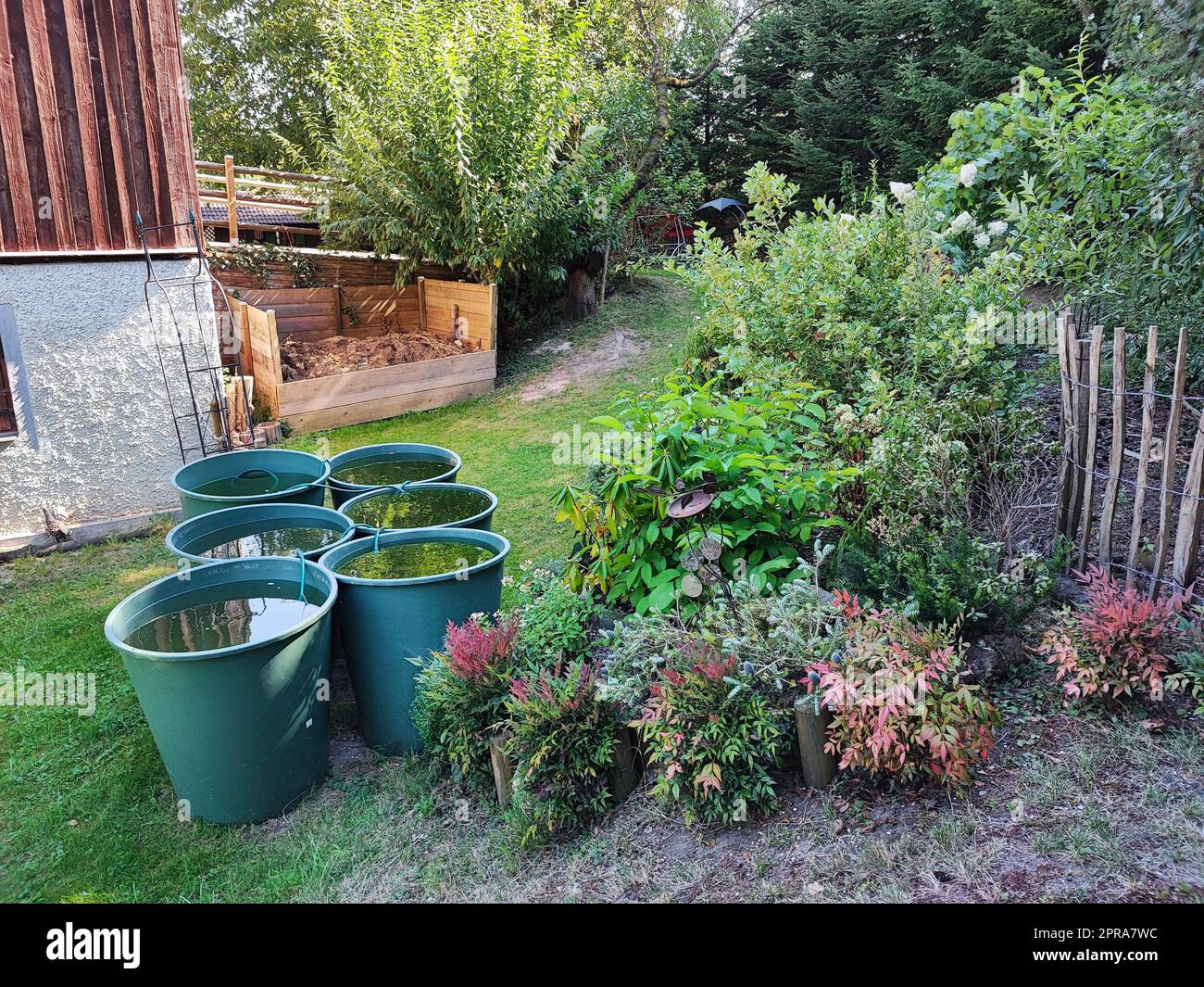 Rain barrels in a garden stock photo alamy